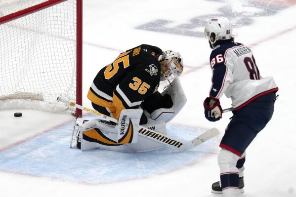 Columbus Blue Jackets' Kirill Marchenko (86) gets his game-winning shootout goal behind Pittsburgh Penguins goaltender Tristan Jarry (35) during an NHL hockey game in Pittsburgh, Tuesday, Jan. 7, 2025. (AP Photo/Gene J. Puskar)