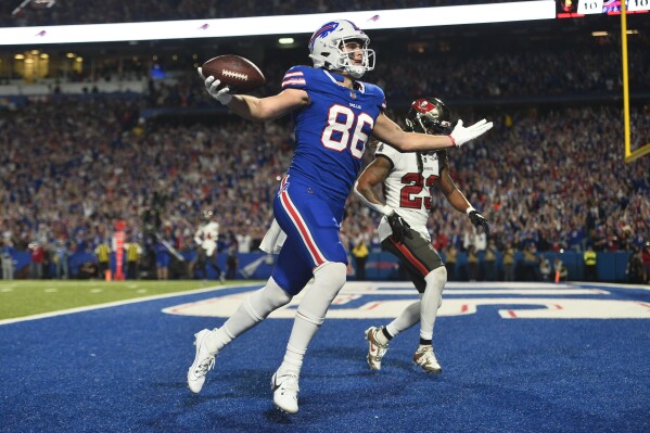 Buffalo Bills tight end Dalton Kincaid (86) gestures after scoring in front of Tampa Bay Buccaneers safety Ryan Neal, right, in the first half of an NFL football game, Thursday, Oct. 26, 2023, in Orchard Park, N.Y. (AP Photo/Adrian Kraus)