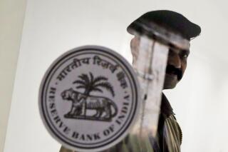FILE- A security guard stands at the entrance of the Reserve Bank of India in Mumbai, India, Oct. 4, 2019.India’s central bank on Wednesday raised its key interest rate to 4.9% from 4.4%, a second such hike in the last three weeks aimed at containing fast-rising inflation. (AP Photo/Rajanish Kakade, File)