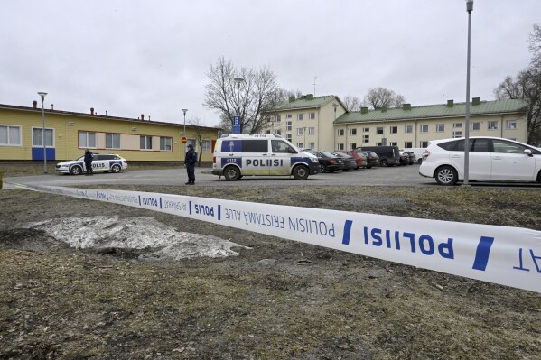 Police officers stand guard outside Viertola comprehensive school, in Vantaa, Finland, Tuesday, April 2, 2024. Police in Finland say a 12-year-old student has opened fire at a secondary school in southern Finland and wounded three other students. The suspect was later arrested. Heavily armed police on Tuesday cordoned off the lower secondary school, with some 800 students, in the city of Vantaa, just outside the capital, Helsinki, after receiving a call about a shooting incident at 09:08 a.m. Police said both the suspect and the wounded were 12 years old. (Markku Ulander/Lehtikuva via AP)