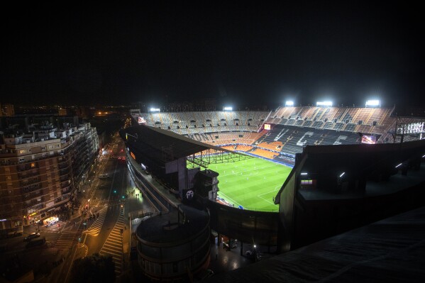 FILE - General view of the Mestalla stadium played in an empty stadium because of the coronavirus outbreak, during the Champions League round of 16 second leg soccer match between Valencia and Atalanta in Valencia, Spain, Tuesday March 10, 2020. Atletico Madrid is revamping its training facilities. Sevilla and Valencia are rebuilding their stadiums. Sporting Gijon is expanding its youth academy. This week Spanish clubs are showcasing projects funded with their shares of the $2.1 billion that private equity group CVC Capital Partners is investing in the Spanish league.(AP Photo/Emilio Morenatti, File)