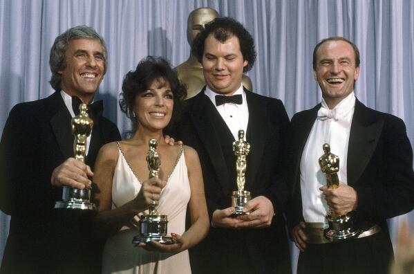 FILE - Burt Bacharach, from left, appears with Carole Bayer Sager, Christopher Cross and Peter Allen, winners of the Oscar for best original song "Arthur's Theme (Best That You Can Do)" at the 54th Annual Academy Awards in Los Angeles on March 29, 1982. Bacharach died of natural causes Wednesday, Feb. 8, 2023, at home in Los Angeles, publicist Tina Brausam said Thursday. He was 94. (AP Photo/Reed Saxon, File)