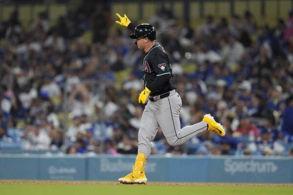 Arizona Diamondbacks' Joc Pederson celebrates as he runs the bases on a three-run home run against the Los Angeles Dodgers during the seventh inning of a baseball game Tuesday, May 21, 2024, in Los Angeles. (AP Photo/Marcio Jose Sanchez)