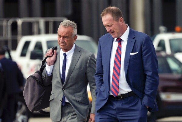 Robert F. Kennedy Jr., walks on the tarmac as Republican presidential nominee former President Donald Trump arrives at Detroit Metropolitan Wayne County Airport, Friday, Nov. 1, 2024, in Romulus, Mich. (AP Photo/Julia Demaree Nikhinson)