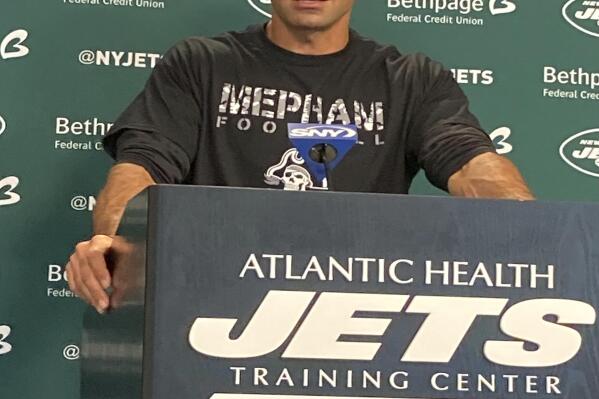 New York Jets coach Robert Saleh speaks to reporters at the team's facility in Florham Park, N.J., on Friday, Sept. 24, 2021, wearing a Mepham High School T-shirt. Saleh wore the shirt to recognize Mepham wide receiver Sofia LaSpina, who was the first female to score a touchdown in Long Island varsity football history. (AP Photo/Dennis Waszak Jr.)