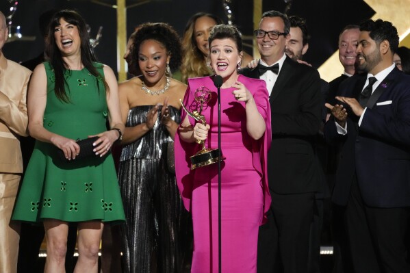 Kelly Clarkson, center, and the team from "The Kelly Clarkson Show" accept the award for outstanding daytime talk series during the 51st Daytime Emmy Awards on Friday, June 7, 2024, at the Westin Bonaventure in Los Angeles. (AP Photo/Chris Pizzello)
