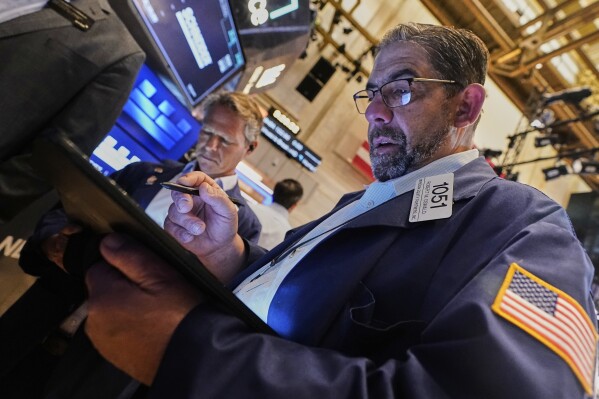 Trader Robert Oswald, right, works on the floor of the New York Stock Exchange, Tuesday, May 20, 2025. (AP Photo/Richard Drew)