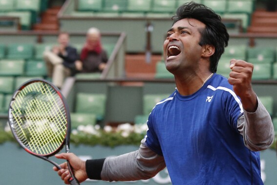 FILE - In this June 3, 2016 file photo, India's Leander Paes celebrates when playing with Switzerland's Martina Hingis in the mixed doubles final of the French Open tennis tournament against India's Sania Mirza and Croatia's Ivan Dodic at Roland Garros stadium in Paris, France. Leander Paes, the owner of 18 Grand Slam titles in men’s doubles or mixed doubles, is the first Asian man to be nominated for the International Tennis Hall of Fame in the player category, announced Tuesday, Sept. 26, 2023.(AP Photo/Alastair Grant, File)