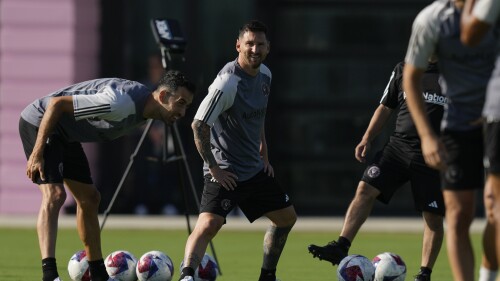 Lionel Messi, center, and Sergio Busquets, left, stretch during a training session for the Inter Miami MLS soccer team Tuesday, July 18, 2023, in Fort Lauderdale, Fla.(AP Photo/Rebecca Blackwell)