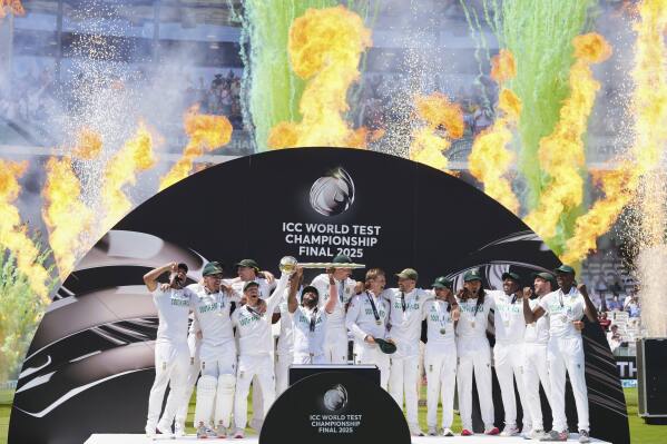 South African players celebrate with the winner's trophy after their win in the World Test Championship final against Australia at Lord's cricket ground in London, Saturday, June 14, 2025. (AP Photo/Kirsty Wigglesworth)