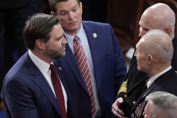 Vice President JD Vance speaks with Vice Chairman of the Joint Chiefs of Staff Admiral Christopher Grady and others, in the House Chamber before President Donald Trump arrives to address a joint session of Congress at the Capitol in Washington, Tuesday, March 4, 2025. (AP Photo/J. Scott Applewhite)