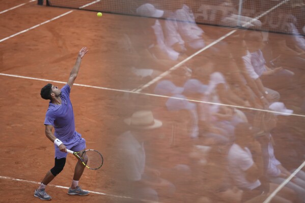 Spain's Carlos Alcaraz serves during a round of sixteen match against Russia's Karen Khachanov at the Italian Open tennis tournament in Rome, Tuesday, May 13, 2025. (AP Photo/Andrew Medichini)