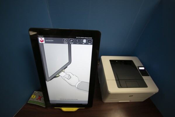 FILE -- A Dominion Voting system used to cast-in person ballots in Georgia is shown Monday, Sept. 16, 2019, in Atlanta. A Georgia Senate committee voted on Thursday, Jan. 25, 2024, to support a bill that would remove the computerized codes that are now printed on ballots and used to count them. (AP Photo/John Bazemore)
