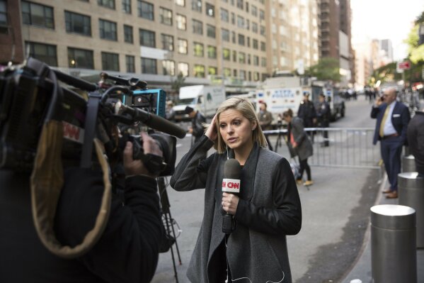 
              CNN correspondent Kate Bolduan reports from in front of the Time Warner Building, where NYPD personnel removed an explosive device Wednesday, Oct. 24, 2018, in New York. Other packages were sent to the offices of Gov. Andrew Cuomo and to the home of President Bill Clinton. (AP Photo/Kevin Hagen)
            