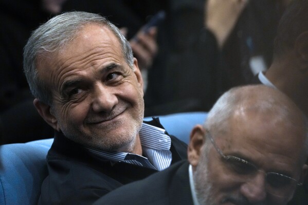 Iranian President Masoud Pezeshkian sits as he arrives at his press conference in Tehran, Iran, Monday, Sept. 16, 2024. (AP Photo/Vahid Salemi)