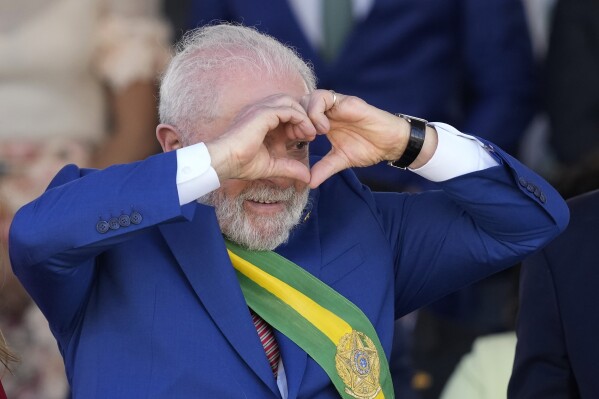 Brazilian President Luiz Inacio Lula da Silva makes a heart sign during a military parade on Independence Day in Brasilia, Brazil, Thursday, Sept. 7, 2023. (AP Photo/Eraldo Peres)