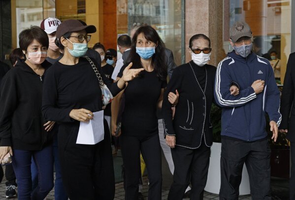 Family members of Macau tycoon Stanley Ho, including Angela Leong On-kei, left, walk out from a hospital, Hong Kong, Tuesday, May 26, 2020. Stanley Ho, the dashing billionaire and bon vivant who was considered the father of modern gambling in China, has died, his daughter Pansy Ho said Tuesday. He was 98. (AP Photo/Kin Cheung)