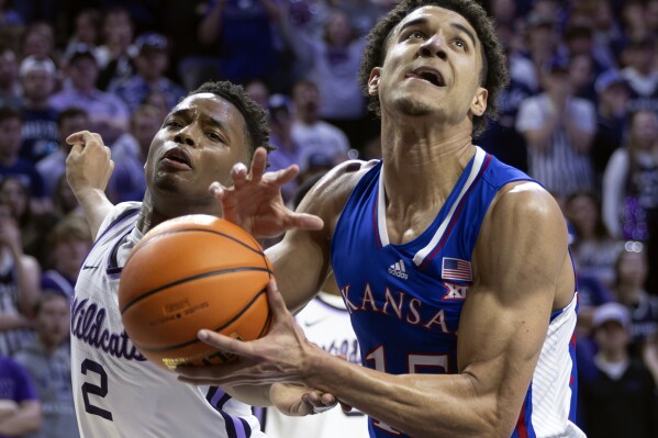 Kansas' Kevin McCullar Jr., right, has the ball stripped away by Kansas State's Tylor Perry, left, during the first half of an NCAA college basketball game Monday, Feb. 5, 2024, in Manhattan, Kan. (Travis Heying/The Wichita Eagle via AP)