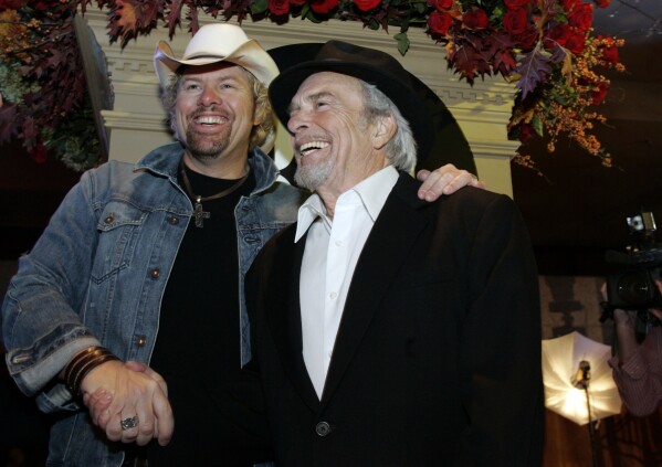 FILE - Toby Keith, left, at the 54th Annual Broadcast Music Inc.  Shaking hands with Merle Haggard at the Country Awards on Saturday, November 4, 2006 in Nashville, Tennessee.  Keith's hit 