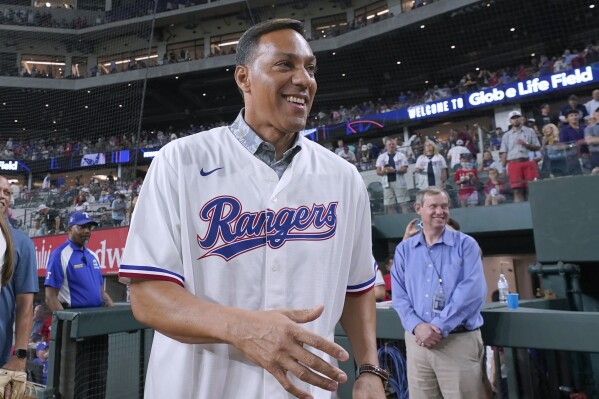 Juan Gonzalez walks onto the field before a baseball game between the Texas Rangers and the Seattle Mariners in Arlington, Texas, Friday, Sept. 22, 2023. Gonzalez received his Texas Rangers Hall of Fame jacket in a pregame ceremony, eight years after his induction and 20 years after his last game for the team. (AP Photo/LM Otero)