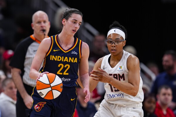 Indiana Fever guard Caitlin Clark (22) drives on Atlanta Dream guard Allisha Gray (15) during the first half of a preseason WNBA basketball game in Indianapolis, Thursday, May 9, 2024. (AP Photo/Darron Cummings)