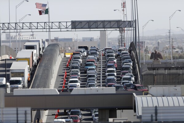 FILE - Cars and trucks line up to enter the U.S. from Mexico at a border crossing in El Paso, Texas, March 29, 2019. Most Americans think the U.S. has been significantly changed by immigrants over the past five years and while many agree immigrants contribute to the economy, there are broad concerns that even legal immigration brings risks as well, according to a new poll from The Associated Press-NORC Center for Public Affairs Research, conducted March 21-25, 2024. (AP Photo/Gerald Herbert, File)