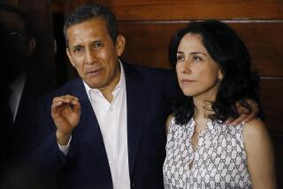 FILE - Peru's former President Ollanta Humala is accompanied by his wife Nadine Heredia as he speaks to reporters at the entrance of their home after they were released from prison in Lima, Peru, April 30, 2018. The couple goes on trial on Feb. 21, 2022, accused of money laundering in a criminal organization, the first trial for corruption against a former president in a case linked to the Brazilian construction company Odebrecht. (AP Photo/Joel Alonzo, File)