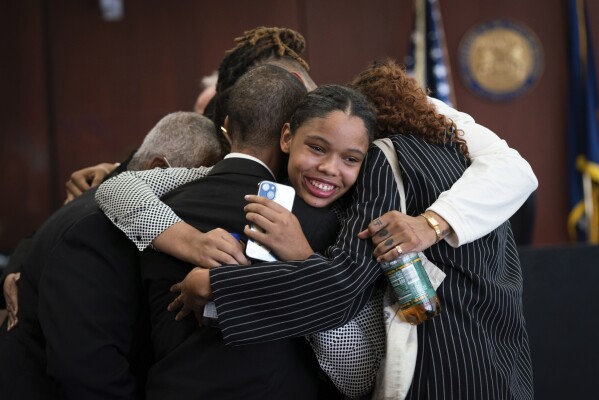 Aretha Franklin's granddaughter Grace Franklin, 17, smiles while embracing her family members after the jury decided in favor of a 2014 document during a trial over her grandmother's wills at Oakland County Probate Court in Pontiac, Mich., on Tuesday, July 11, 2023. The Queen of Soul died in 2018 at age 76. (Sarahbeth Maney/Detroit Free Press via AP)
