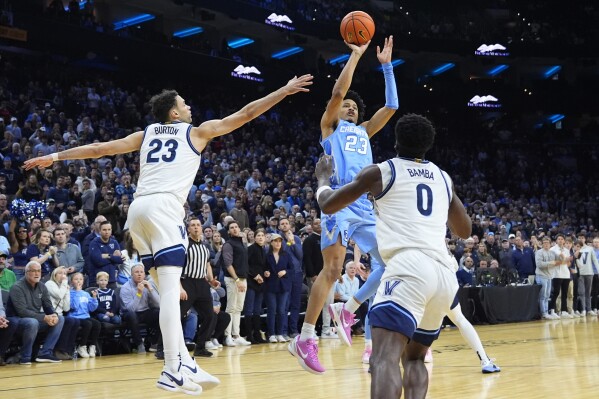 Creighton's Trey Alexander, center, goes up for the go-ahead basket between Villanova's Tyler Burton, left, and TJ Bamba during the final seconds of an NCAA college basketball game, Saturday, March 9, 2024, in Philadelphia. (AP Photo/Matt Slocum)