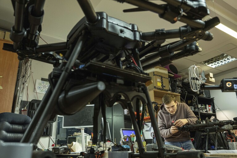 An engineer assembles parts on a combat drone in Kyiv region, Ukraine, on Monday, February 6, 2023. (AP Photo/Evgeniy Maloletka)
