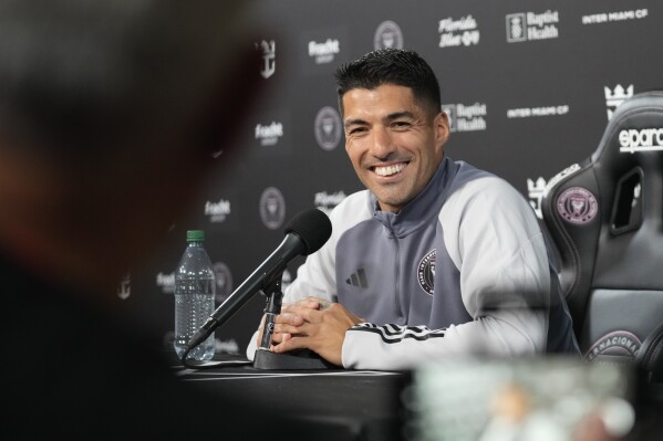 Inter Miami forward Luis Suarez listens to a question from a journalist, during a press conference following a training session with the MLS soccer team, Saturday, Jan. 13, 2024, in Fort Lauderdale, Fla. (AP Photo/Rebecca Blackwell)