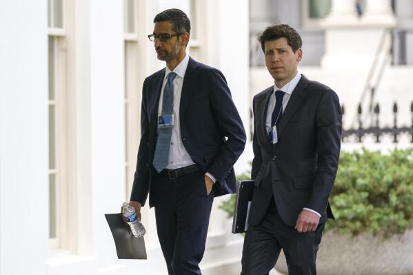 File - Alphabet CEO Sundar Pichai, left, and OpenAI CEO Sam Altman arrive to the White House for a meeting with Vice President Kamala Harris on artificial intelligence, Thursday, May 4, 2023, in Washington. As concerns grow over increasingly powerful artificial intelligence systems like ChatGPT, the nation's financial watchdog says it's working to ensure that companies follow the law when they're using AI. (AP Photo/Evan Vucci, File)