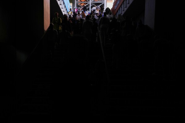 Spectators walk out of the Madrid Open tennis tournament venue during a general blackout in Madrid, Monday, April 28, 2025. (AP Photo/Manu Fernandez)