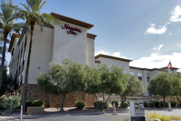 A Hampton Inn is shown Tuesday, July 21, 2020 in Phoenix.  The Trump administration is detaining immigrant children as young as 1 in hotels before deporting them to their home countries. Documents obtained by The Associated Press show a private contractor hired by U.S. Immigration and Customs Enforcement is taking children to three Hampton Inns in Arizona and Texas under restrictive border policies implemented during the coronavirus pandemic.  (AP Photo/Matt York)