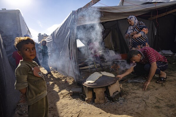 FILE - Palestinians displaced by the Israeli bombardment of the Gaza Strip prepare bread at a UNDP-provided tent camp in Khan Younis, Wednesday, Nov. 15, 2023. Since the the fighting began, around 22,000 people have taken shelter there. (AP Photo/Fatima Shbair, File)