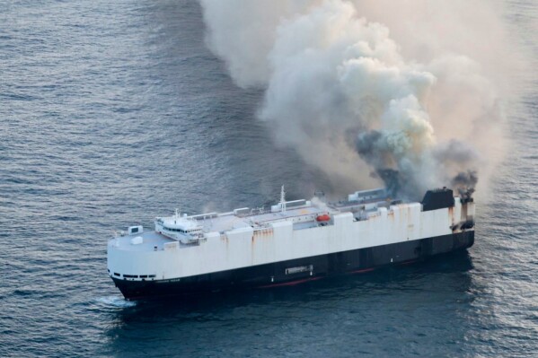 In this photo provided by the U.S. Coast Guard, smoke rises from cargo vessel Morning Midas approximately 300 miles south of Adak, Alaska, June 3, 2025, as the crew of a cargo ship carrying around 3,000 vehicles to Mexico, abandoned ship after they could not control a fire. (U.S. Coast Guard/Courtesy Air Station Kodiak via AP)