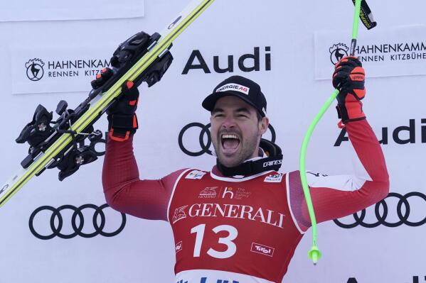 Austria's Vincent Kriechmayr celebrates on the podium after winning the alpine ski, men's World Cup downhill race in Kitzbuehel, Austria, Friday, Jan. 20, 2023. (AP Photo/Giovanni Auletta)