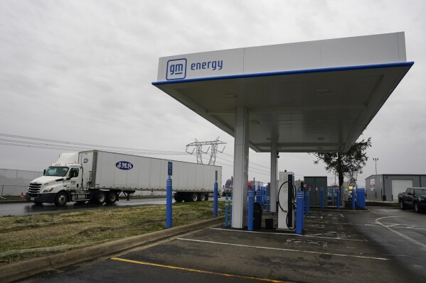 A truck drives by an electrical automobile charging station, Friday, March 8, 2024, in London, Ohio. The charging ports are a crucial part of President Joe Biden's effort to motivate motorists to move far from gasoline-powered automobiles and trucks that add to worldwide warming. (AP Photo/Joshua A. Bickel)