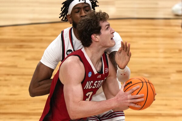 North Carolina State's Ben Middlebrooks, front, goes to the basket with Texas Tech's Warren Washington, rear, defending during the first half of a college basketball game in the first round of the men's NCAA Tournament in Pittsburgh, Thursday, March 21, 2024. (AP Photo/Gene J. Puskar)