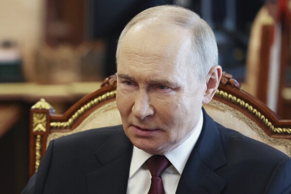 Russian President Vladimir Putin speaks with Russian Chief of General Staff Gen. Valery Gerasimov during their meeting at the Kremlin in Moscow, Russia, Saturday, April 19, 2025. (Vyacheslav Prokofyev, Sputnik, Kremlin Pool Photo via AP)