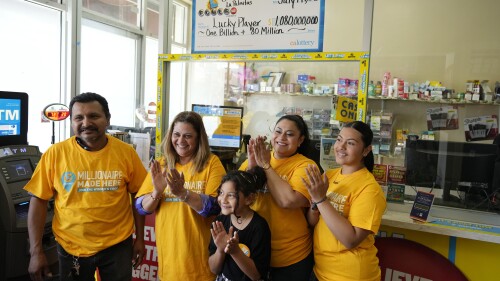 Store manager Navor Herrera, left, stands with family members, including wife and store owner Maria Menjivar, second from left, stepdaughter Angelica Menjivar, second from right, and Angelica's daughters Natalie Palacios, 9, center, and Sarai Palacios, right, inside the Las Palmitas Mini Market in downtown Los Angeles, Thursday, July 20, 2023, where the winning Powerball lottery ticket, worth an estimated $1.08 billion, was sold. (AP Photo/Marcio Jose Sanchez)