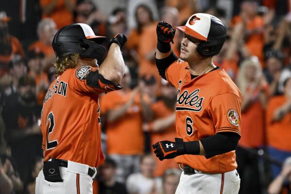 Baltimore Orioles' Ryan Mountcastle (6) is greeted by Gunnar Henderson (2) after hitting a two-run home run against Oakland Athletics starting pitcher Adam Oller which scored Anthony Santander during the third inning of a baseball game, Saturday, Sept. 3, 2022, in Baltimore. (AP Photo/Terrance Williams)