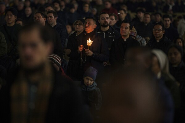 Catholic worshipers meet during a prayer of the Rosary for Pope Francis on Place Saint-Pierre at the Vatican, Monday, February 24, 2025. (AP Photo / Bernat Armangue)