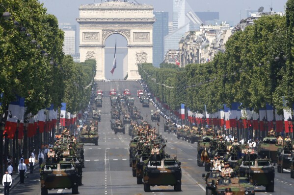 FILE - French VAB armored personnel carriers, front rows from left, attend the Bastille Day parade in Paris, July 14, 2013. French Defense Minister Sébastien Lecornu said France is going to deliver “hundreds” of armored vehicles by the beginning of next year to Ukraine. (AP Photo/Francois Mori, File)