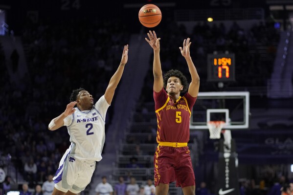 Iowa State guard Curtis Jones (5) shoots over Kansas State guard Tylor Perry (2) during the first half of an NCAA college basketball game Saturday, March 9, 2024, in Manhattan, Kan. (AP Photo/Charlie Riedel)