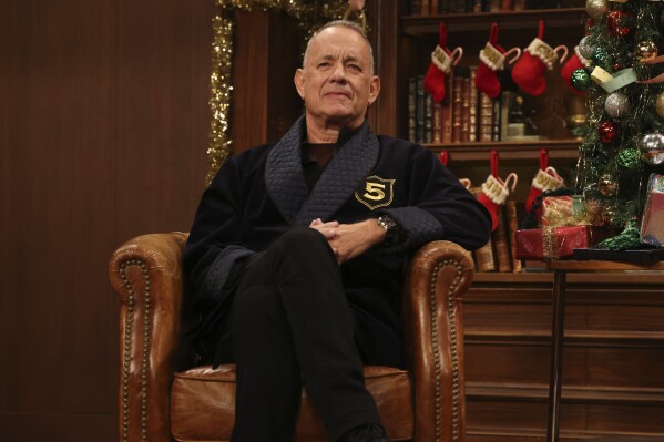 This image released by NBC shows Tom Hanks making a guest appearance during the "5 Timers Club" Cold Open for "Saturday Night Live" on Dec. 21, 2024, in New York. (Will Heath/NBC via AP)