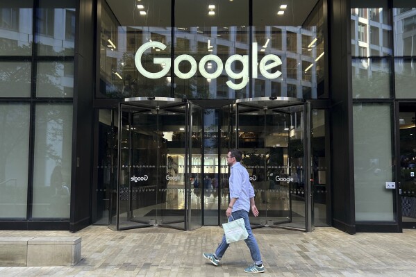 A man walks past Google's offices in London's Kings Cross area, on Aug. 10, 2024. (AP Photo/Brian Melley, File)