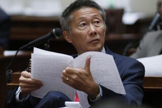 FILE - In this May 17, 2016, file photo, Oklahoma state Sen. Ervin Yen, R-Oklahoma City, works on the Senate floor in Oklahoma City. Former state Sen. Ervin Yen, the first Republican candidate to challenge Oklahoma Gov. Kevin Stitt said he’s leaving the party and will run against Stitt as an independent. Ervin Yen, an Oklahoma City physician, said in a statement Tuesday, Oct. 19, 2021, that he disagrees with the state party’s opposition to mask and vaccine mandates, and the insistence of some party officials that the 2020 election was stolen from former President Donald Trump. (AP Photo/Sue Ogrocki, File)