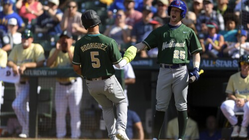 Chicago Cubs' Pete Crow-Armstrong greets Pittsburgh Pirates' Endy Rodriguez, who had scored during the second inning of the All-Star Futures baseball game Saturday, July 8, 2023, in Seattle. (AP Photo/Caean Couto)