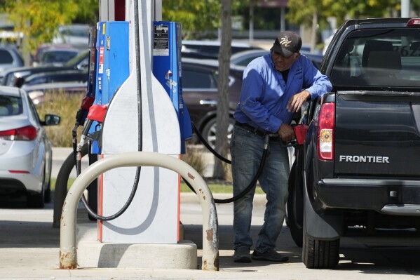 A man fuels his truck at a gas station in Palatine, Ill., Wednesday, Sept. 13, 2023. Higher longer-term interest rates coincide with other threats to economic growth, from higher gas prices and the resumption of student loan payments to the autoworkers’ strike and the risk of a government shutdown next month. (AP Photo/Nam Y. Huh)